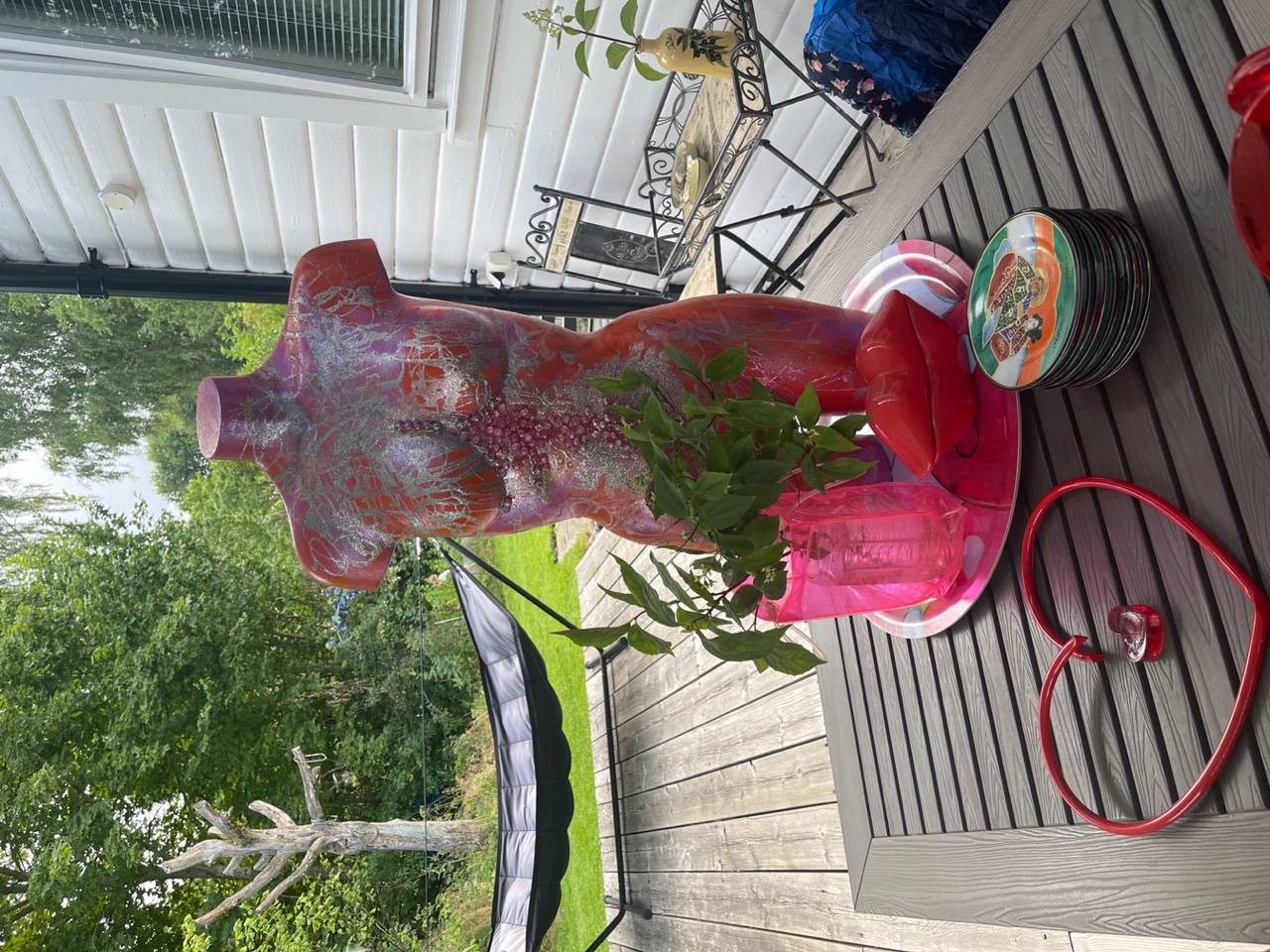 Inredningsdetaljer, hjärta av rött stålrör, gammal telefon i form av en pussmun, en rosa kvinno-torso med text på 